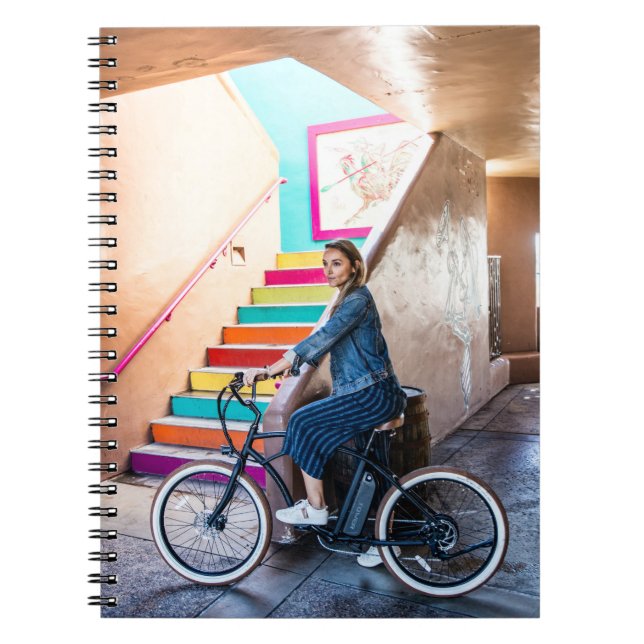 Woman wearing blue denim jacket and shorts riding  notebook (Front)