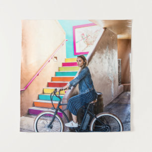 Woman wearing blue denim jacket and shorts riding  tapestry