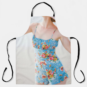 Woman wearing blue floral rompers and brown hat apron