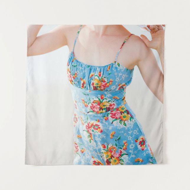 Woman wearing blue floral rompers and brown hat tapestry (Front)