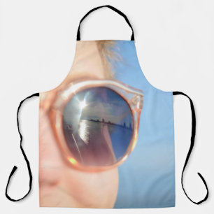 Woman wearing brown framed sunglasses apron