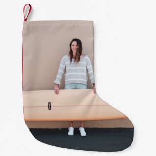 Woman wearing grey and white stripe long-sleeved s small christmas stocking