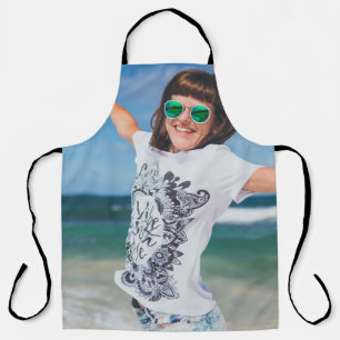 Woman wearing white and black shirt jumping near s apron