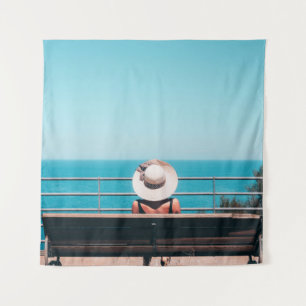 Woman wearing white straw hat sitting on bench loo tapestry