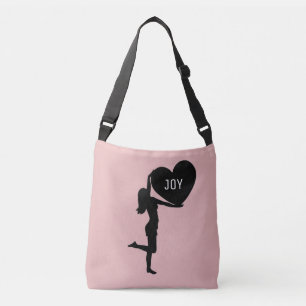 Woman with heart black silhouette on rose gold crossbody bag