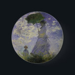 Woman with Parasol by Claude Monet, Vintage Art 6 Cm Round Badge<br><div class="desc">The Stroll, Camille Monet and Her Son Jean (Woman with a Parasol) (1875) by Claude Monet is a vintage impressionist fine art family portrait painting. A mother taking a walk with her young child in a field or spring meadow. She is holding a sun umbrella and wearing a beautiful dress...</div>