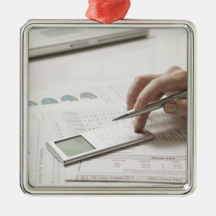 Woman working on financial paperwork and metal ornament