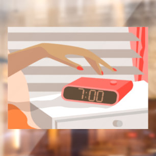 Womans hand pushing on alarm clock snooze button