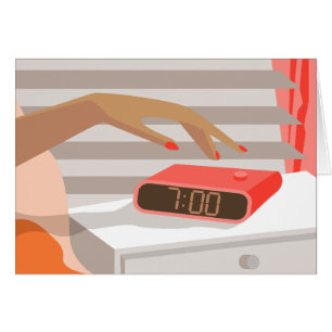 Womans hand pushing on alarm clock snooze button