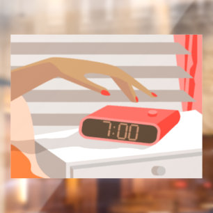 Womans hand pushing on alarm clock snooze button