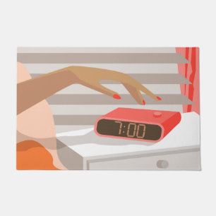 Womans hand pushing on alarm clock snooze button doormat
