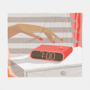 Womans hand pushing on alarm clock snooze button fleece blanket