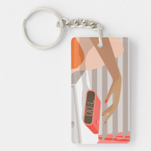 Womans hand pushing on alarm clock snooze button key ring