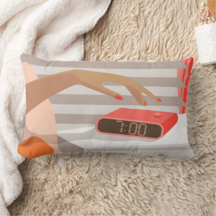 Womans hand pushing on alarm clock snooze button lumbar cushion