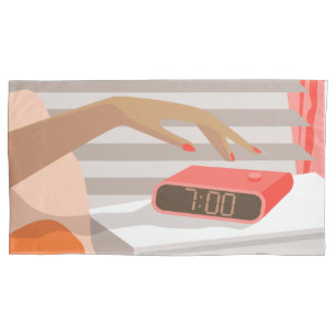 Womans hand pushing on alarm clock snooze button pillowcase