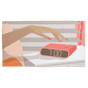 Womans hand pushing on alarm clock snooze button pillowcase
