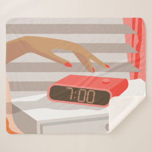 Womans hand pushing on alarm clock snooze button sherpa blanket