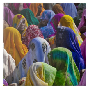 Women in colourful saris gather together tile