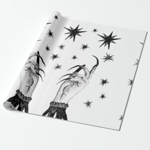 Women witch background with stars, witch hands wit wrapping paper