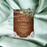 Wood Rustic Greenery Script Wedding Invitation<br><div class="desc">Step into a world of rustic charm with our beautifully crafted wedding invitation. Set against a backdrop of rustic wood, this design features a delicate arrangement of watercolor greenery leaves, softly lit by string lights at the top for an enchanting touch. The bottom of the card is adorned with an...</div>