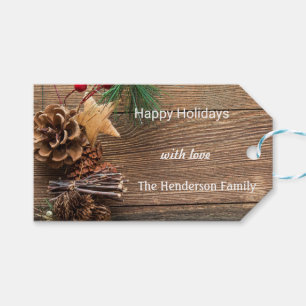 wooden background with pine cones gift tags