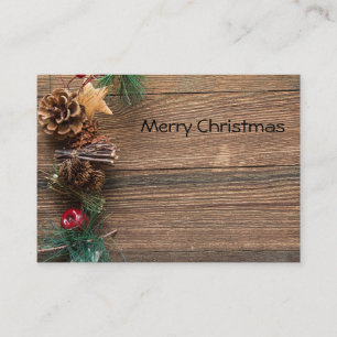 wooden background with pine cones place card