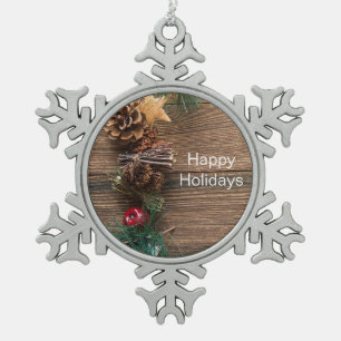 wooden background with pine cones snowflake pewter christmas ornament