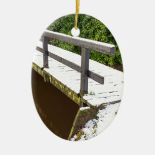 Wooden bridge covered with snow in winter ceramic ornament
