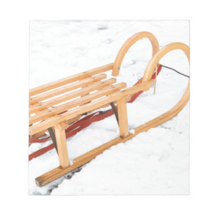 Wooden children sled in winter snow notepad