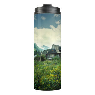 Wooden house, mountain nature scenery. thermal tumbler