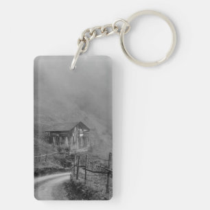 Wooden hut in nature/fog at mountain key ring