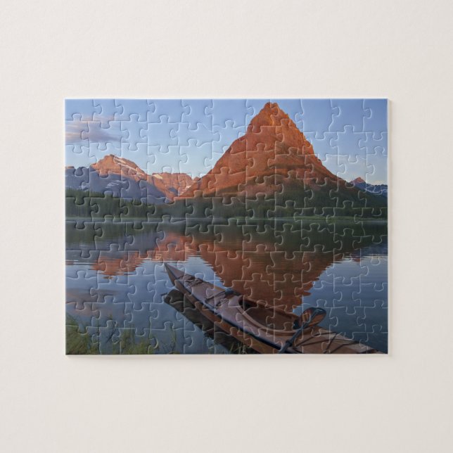 Wooden kayak in Swiftcurrent Lake at sunrise in Jigsaw Puzzle (Horizontal)