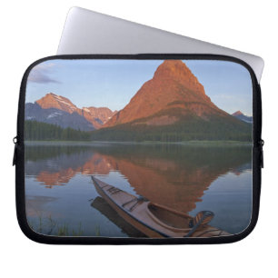 Wooden kayak in Swiftcurrent Lake at sunrise in Laptop Sleeve