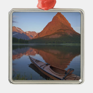 Wooden kayak in Swiftcurrent Lake at sunrise in Metal Ornament