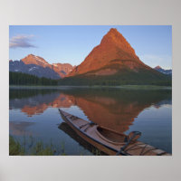 Wooden kayak in Swiftcurrent Lake at sunrise in
