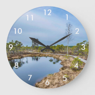 Wooden trail over swamp with tower large clock