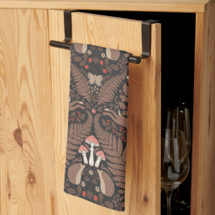 Woodland animals and plants in red and brown tea towel