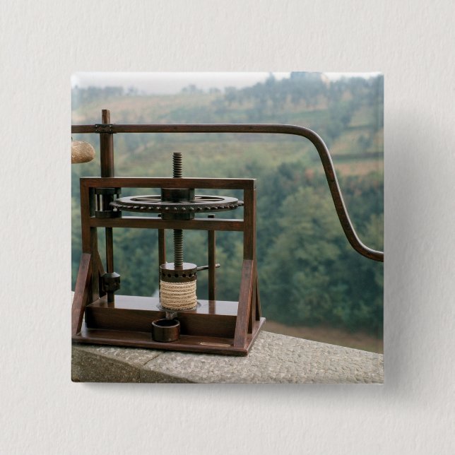 Working model of an olive press 15 cm square badge (Front)