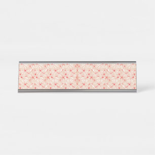 Wrapping paper with a repeating pattern of red, or desk name plate