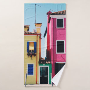 YELLOW AND PINK CONCRETE HOUSES DURING DAYTIME BATH TOWEL