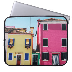 YELLOW AND PINK CONCRETE HOUSES DURING DAYTIME LAPTOP SLEEVE