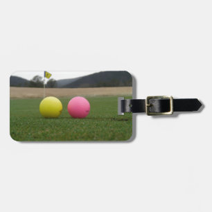 yellow and pink golf balls, luggage tag