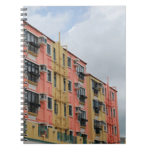 YELLOW AND RED CONCRETE BUILDING UNDER WHITE CLOUD NOTEBOOK