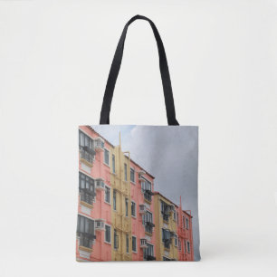 YELLOW AND RED CONCRETE BUILDING UNDER WHITE CLOUD TOTE BAG