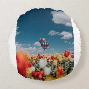 Yellow and red tulip flowers under hot air balloon round cushion