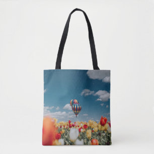 Yellow and red tulip flowers under hot air balloon tote bag