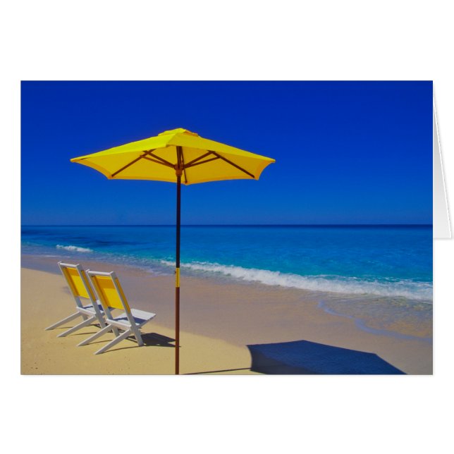 Yellow beach umbrella and chairs on pristine (Front Horizontal)