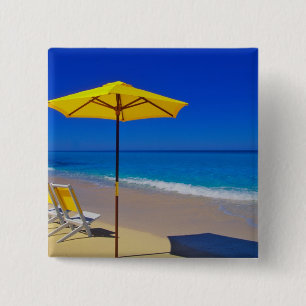 Yellow beach umbrella and chairs on pristine 15 cm square badge