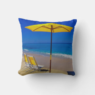 Yellow beach umbrella and chairs on pristine cushion