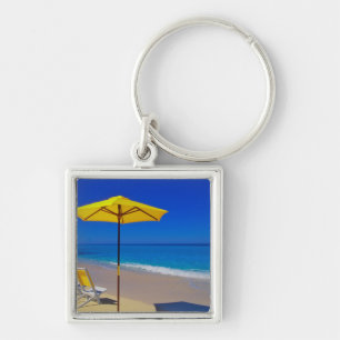 Yellow beach umbrella and chairs on pristine key ring